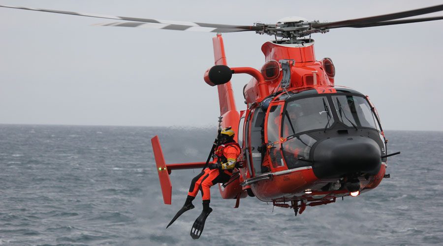 Air-Rescue-Helicopter-With-a-Survival-Swimmer-Hanging-Out-Preparing-for-Mission Air Rescue Helicopter with a Survival Swimmer Hanging Out Preparing for Mission