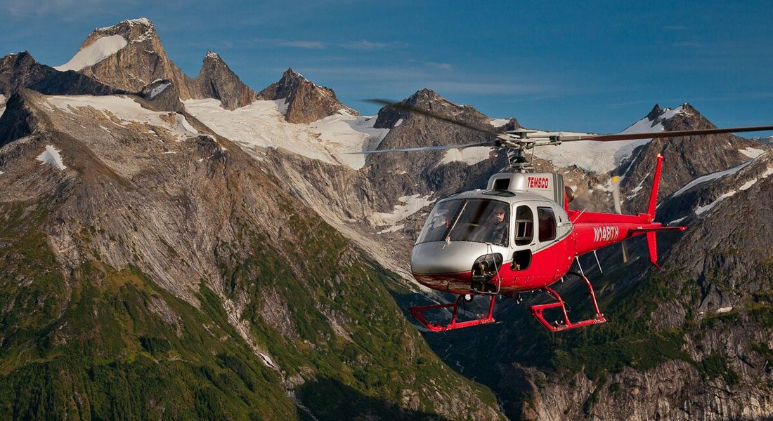 Helicopter flying through mountain range